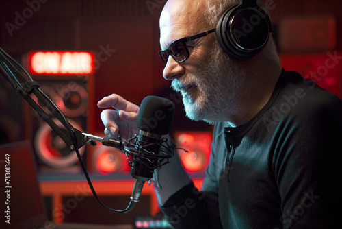 Radio host talking into the microphone photo