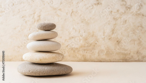 Spa  balance  meditation and zen minimal modern concept. Stack of stone pebbles against beige wall for design and presentation.