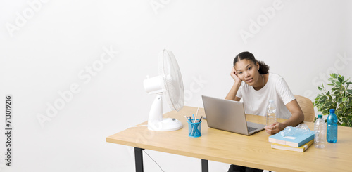 Woman in the office suffering from the heat