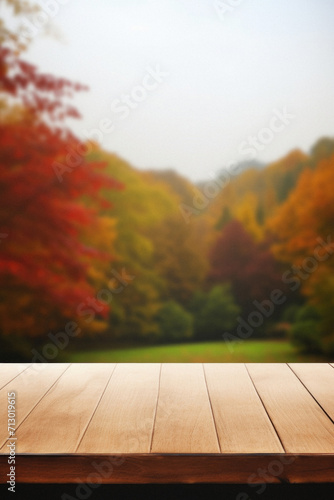 Empty blank wooden table fall background with autumn trees orange yellow color leaves backdrop forest or park nature scene abstract blurred bokeh tabletop for product display desk mockup. Copy space.