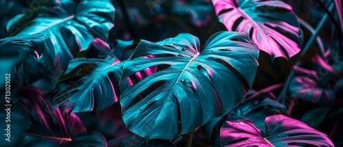 Neon Monstera deliciosa leaves growing in tropical forest for creative design elements. Generative AI photo
