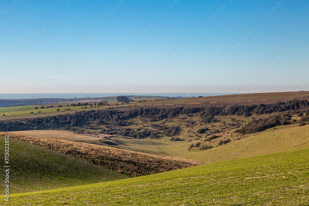 Fototapeta premium Looking out over the Sussex countryside towards the sea, on a sunny winter's day
