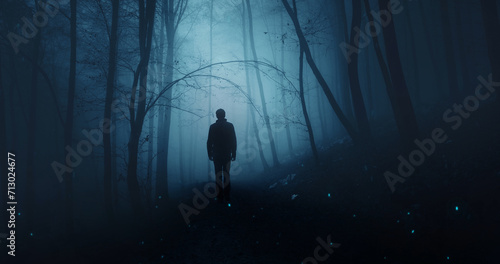  Man silhouette in mystic dark blue foggy forest.