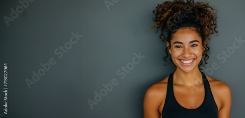 Fitness woman. Young caucasian fitness woman doing sport isolated showing strength gesture with arms. Athletic girl on the gray background. Sport and recreation concept. photo