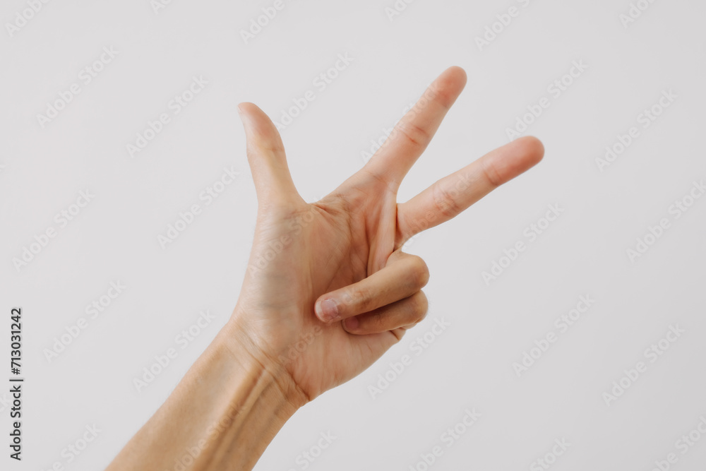 Photo of woman's hand showing numbers three, counting fingers gesture, isolated on white background wall. Photo of woman's hand showing numbers three, counting fingers gesture, isolated on white background wall.