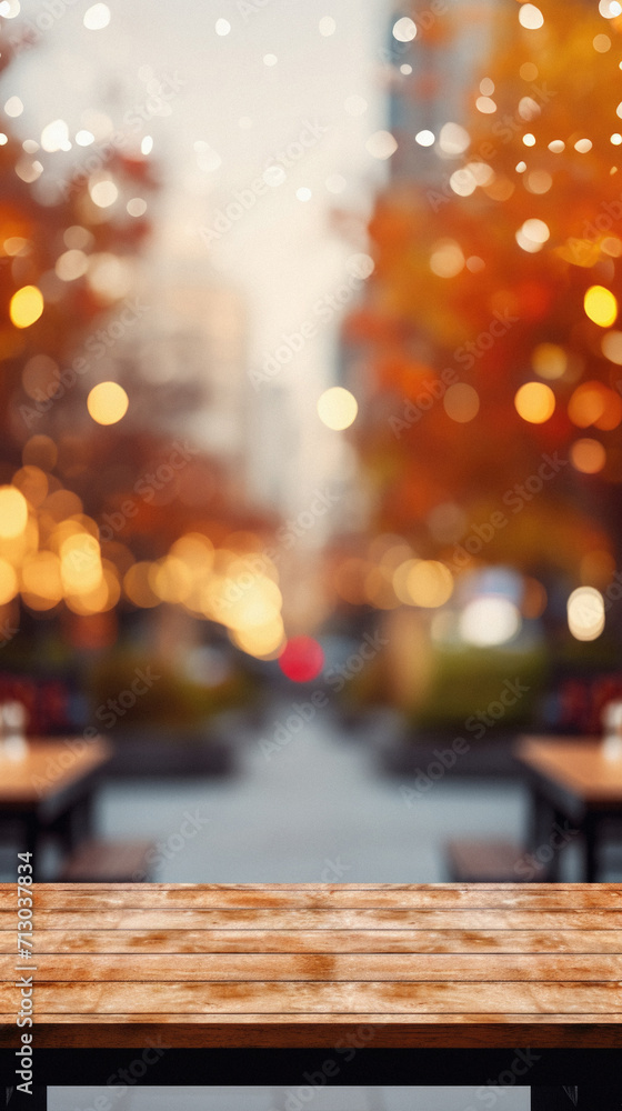 Empty blank wooden table fall background with autumn trees orange yellow color leaves backdrop forest or park nature scene abstract blurred bokeh tabletop for product display desk mockup. Copy space. Empty blank wooden table fall background with autumn trees orange yellow color leaves backdrop forest or park nature scene abstract blurred bokeh tabletop for product display desk mockup. Copy space.