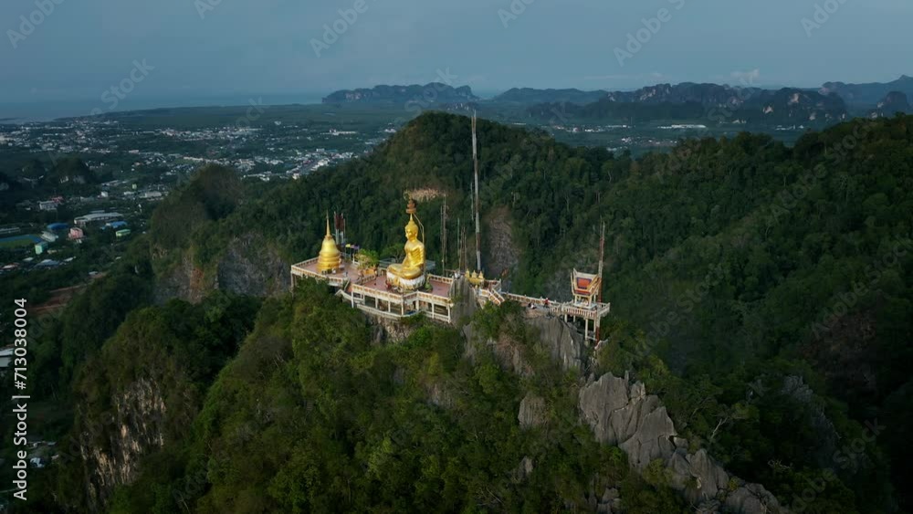 Aerial orbiting shot of Tiger Cave Temple on top of limestone mountain in Krabi, Thailand Aerial orbiting shot of Tiger Cave Temple on top of limestone mountain in Krabi, Thailand