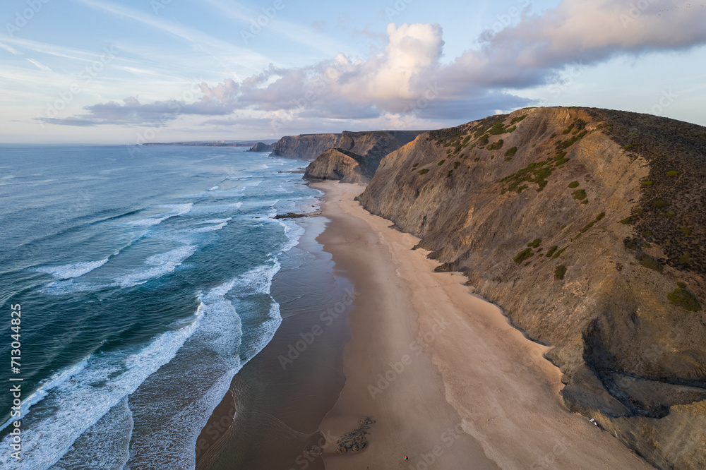 Cordoama beach in Portugal. Aerial drone view of waves, sandy beach and cliffs