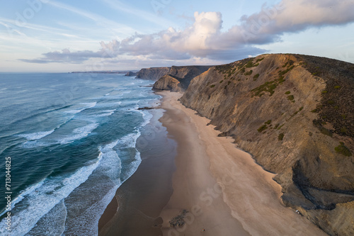 Cordoama beach in Portugal. Aerial drone view of waves, sandy beach and cliffs