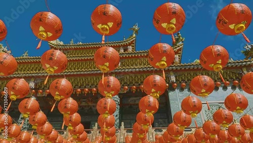 Facade of asian buddhist temple in Taiwan with decoration of red lantern. Travel in asia, discover Jiufen and Xiahai City God temple. Historical religious building in chinese style.