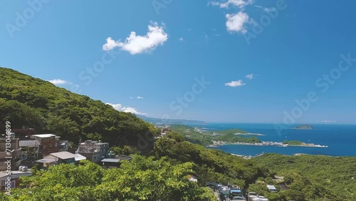 Panoramic view of hills  and taiwanese seain a sunny day. Travel in asia Taiwan. Scenic view point in Jiufen. Cloudy sky over hills near the sea. photo
