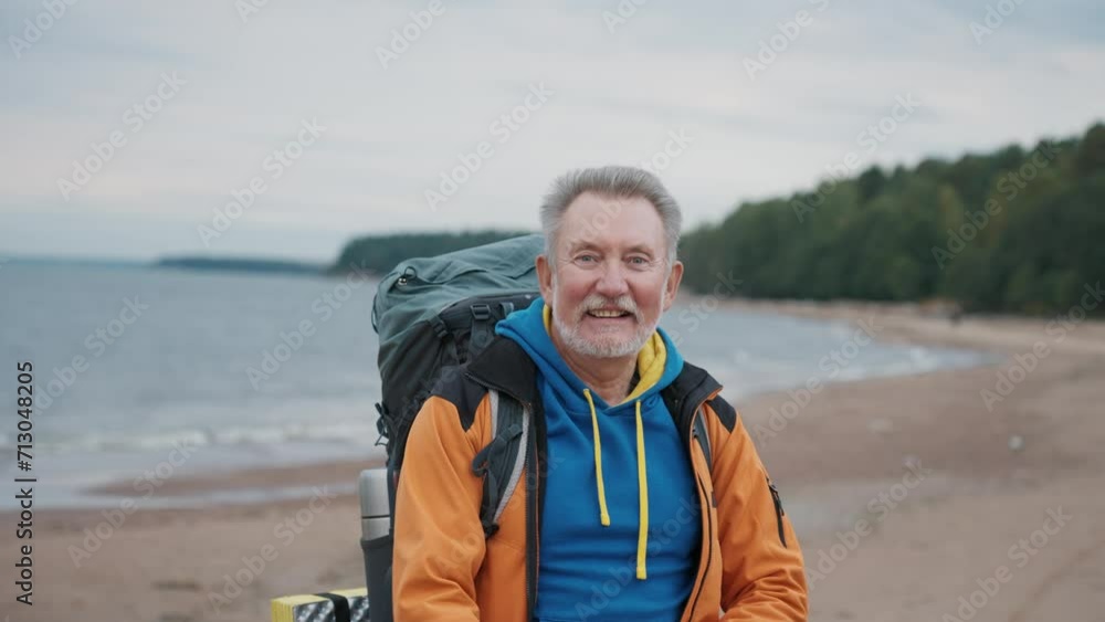 Portrait happy senior gray haired man traveler tourist hiker carrying backpack with touristic equipment. Old healthy male enjoying nature river, forest. Travel tourism trip hiking journey concept. Portrait happy senior gray haired man traveler tourist hiker carrying backpack with touristic equipment. Old healthy male enjoying nature river, forest. Travel tourism trip hiking journey concept.
