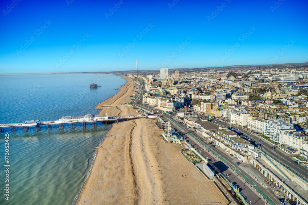 Aerial photo revealing Brighton Beach towards the Victorian Palace Pier, a popular seaside resort in East Sussex England.