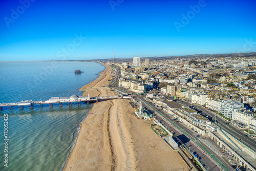 Aerial photo revealing Brighton Beach towards the Victorian Palace Pier, a popular seaside resort in East Sussex England.