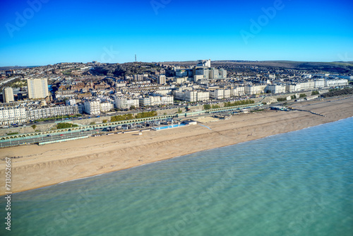 Aerial view of Brighton seafront with Victorian buildings along Marine Drive and Madeira Drive with the Volks Electric Railway in the foreground.