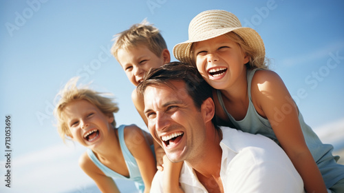 Portrait of happy family having fun on the beach against blue sky
