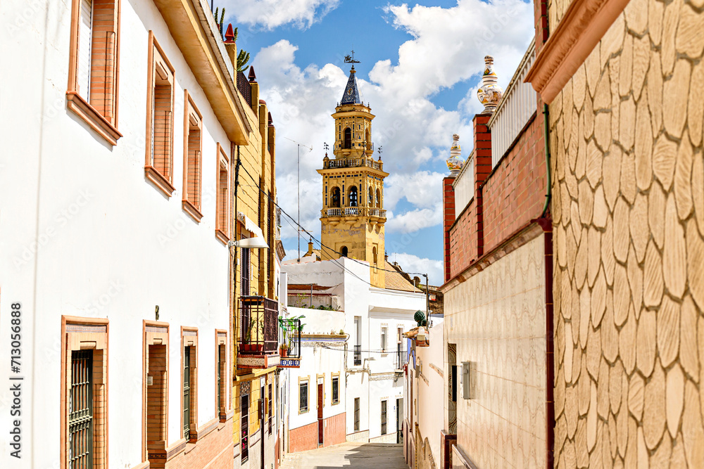 Fototapeta premium View of the bell tower of the church of Santiago de Alcalá de Guadaíra, from San Miguel street. Seville