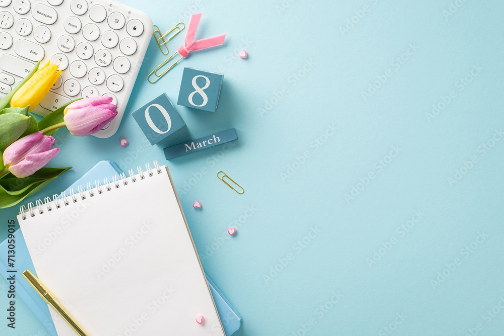 Celebrating the businesswoman: Top view of a stylish office setup featuring a keyboard, cube calendar with 8th March, notepads, pen, clips, and tulips. Pastel blue background with space for text Celebrating the businesswoman: Top view of a stylish office setup featuring a keyboard, cube calendar with 8th March, notepads, pen, clips, and tulips. Pastel blue background with space for text