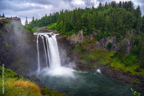 Snoqualmie Falls with lush greenery and mist in Washington State  USA. Snoqualmie Falls is a 268-foot waterfall on the Snoqualmie River between Snoqualmie and Fall City. Long exposure.