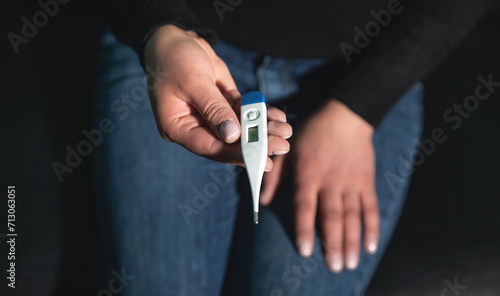 Caucasian young woman showing thermometer.