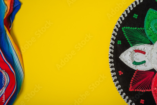 Mariachi hat and serape on yellow background. Mexican independence concept. Cinco de mayo background.