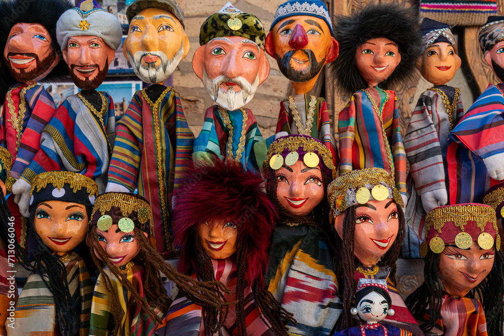 Dolls dressed in traditional uzbek costumes. Traditional souvenir puppet from painted mashed paper papier mache . Itchan Kala Xiva Ichon Qala . Khiva, Uzbekistan. Souvenir and gift concept Dolls dressed in traditional uzbek costumes. Traditional souvenir puppet from painted mashed paper papier mache . Itchan Kala Xiva Ichon Qala . Khiva, Uzbekistan. Souvenir and gift concept