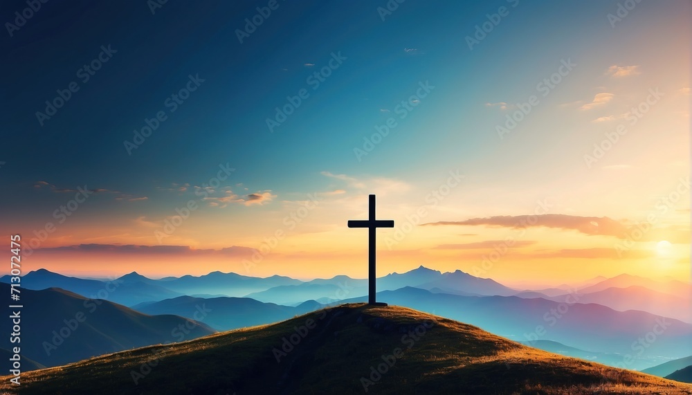 Silhouette of a christian cross on a hill in a mountain landscape at sunset