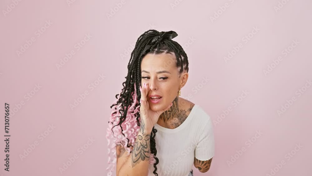Tattooed hispanic amputee woman stands over pink isolated background, hand covering mouth, whispering an intense secret, a conversation of gossip Tattooed hispanic amputee woman stands over pink isolated background, hand covering mouth, whispering an intense secret, a conversation of gossip