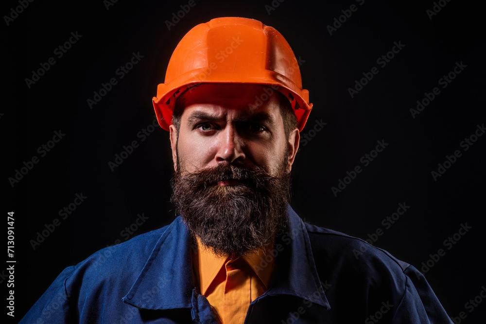 Portrait worker in construction helmet. Builder foreman or repairman in builder uniform. Worker in studio. Construction manager, builder in helmet. Male builder engineer. Portrait worker in construction helmet. Builder foreman or repairman in builder uniform. Worker in studio. Construction manager, builder in helmet. Male builder engineer.