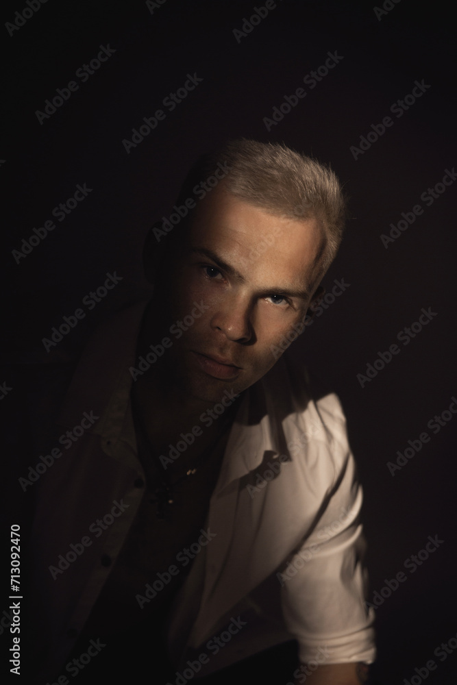 Portrait of a young man with rock musician makeup using a gobo mask. Portrait of a young man with rock musician makeup using a gobo mask.