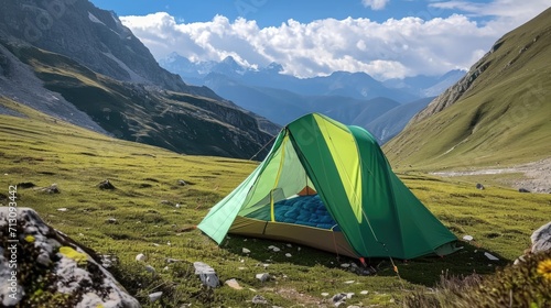 A tent pitched up in the middle of a grassy field