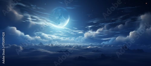 Majestic Full Moon Illuminating Cloud-Filled Night Sky Over a Rugged Mountainous Landscape