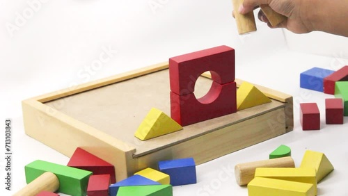 A child play Colorful wooden puzzle toys being assembled