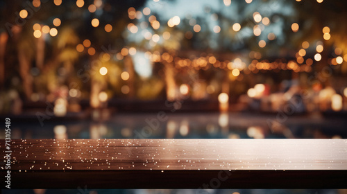 Wooden table pool bokeh background, empty wood desk product display mockup with blurry tropical hotel resort abstract poolside summer travel backdrop advertising presentation. Mock up, copy space. photo