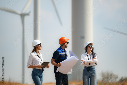 Team of engineers and architects working on wind turbines in a wind farm