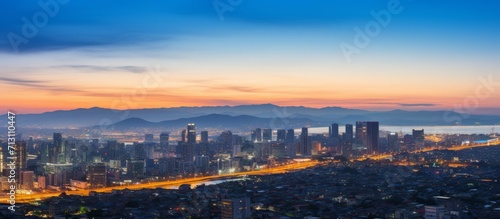 Dazzling City Skyline at Twilight with Mountain Backdrop