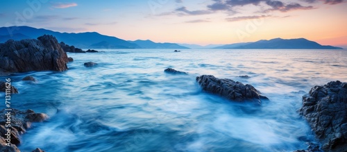 Serene Seascape at Twilight with Rocky Shoreline © Bismillah