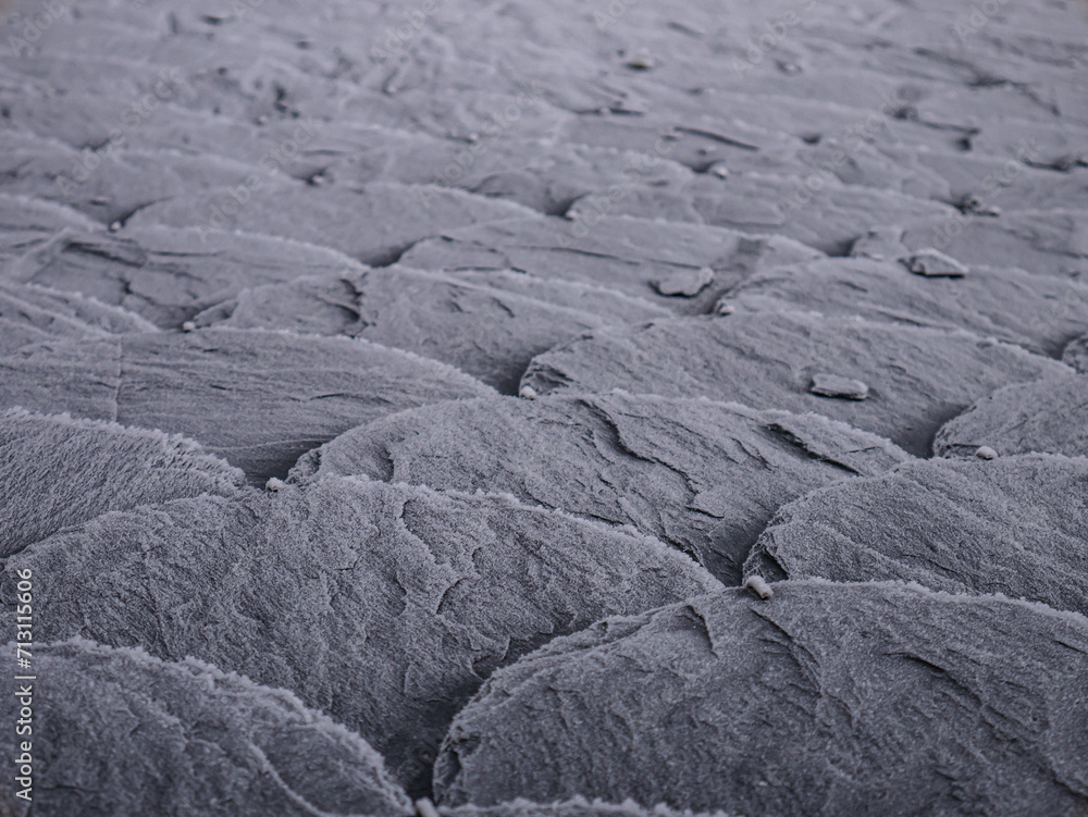 Fototapeta premium Slate slabs of a roof completely frozen with dew by the streak of fog at dawn on a winter day