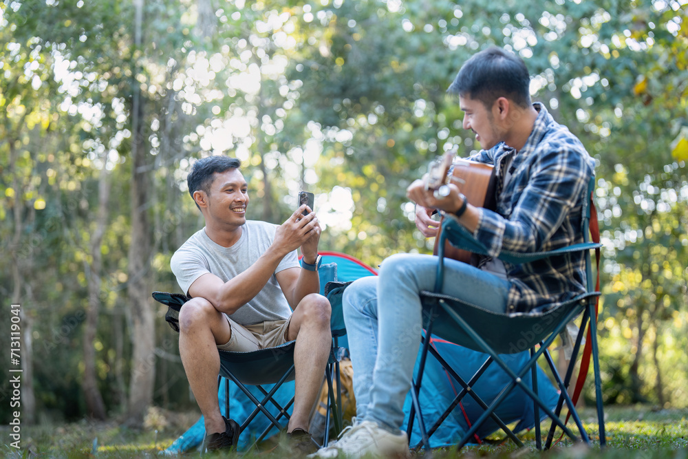 Happy Asian male gay couple on camping together in a forest. romantic vocation trip. lgbt concept Happy Asian male gay couple on camping together in a forest. romantic vocation trip. lgbt concept