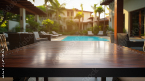 Wooden table pool bokeh background  empty wood desk product display mockup with blurry tropical hotel resort abstract poolside summer travel backdrop advertising presentation. Mock up  copy space.