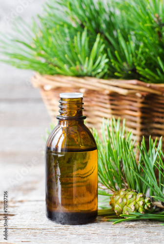Small bottle with essential pine oil. Aromatherapy, herbal medicine, natural skin care, homemade spa and beauty treatment. © kazmulka