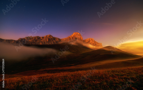 Sunset fog and moonlight in the mountains of Chegem long exposure. Caucasus mountains, Chegem.