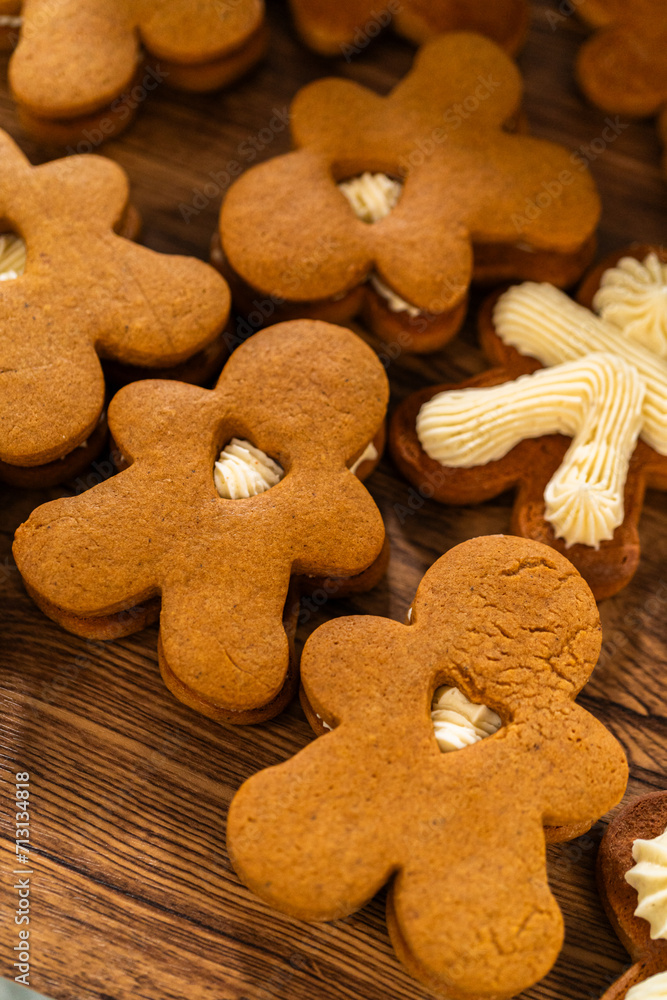 Making Festive Gingerbread Sandwiches on Rustic Wooden Table Making Festive Gingerbread Sandwiches on Rustic Wooden Table