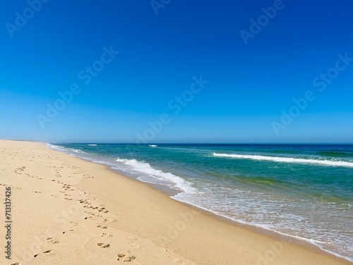 Blue seascape background  clear blue sky and blue sea horizon  sandy coastline