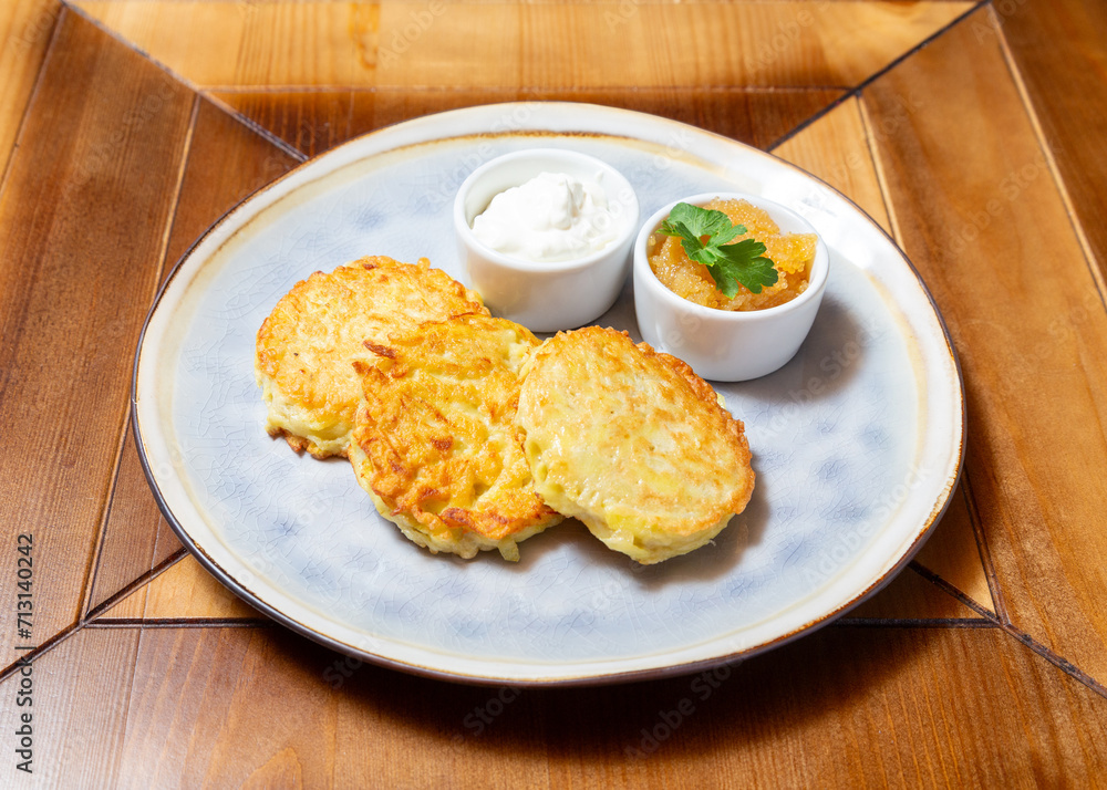 Potato cutlets with sour cream. On a wooden table. Potato cutlets with sour cream. On a wooden table.