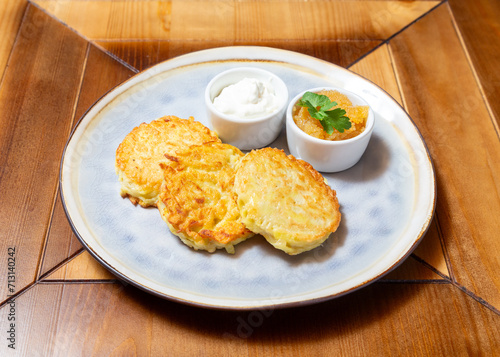 Potato cutlets with sour cream. On a wooden table.