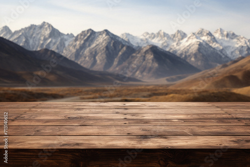 Wooden table mountains bokeh background, empty wood desk surface product display mockup with blurry nature hills landscape abstract travel backdrop advertising presentation. Mock up, copy space.