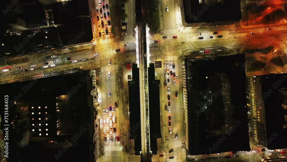 Top down view of vehicles driving through crossroads in evening city. Ubahn train standing in station. Vienna, Austria Top down view of vehicles driving through crossroads in evening city. Ubahn train standing in station. Vienna, Austria