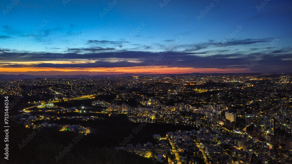 Dusk on top of a mountain in the highest part of the city of Belo Horizonte in Brazil. Sunset and city lights slowly turning on.