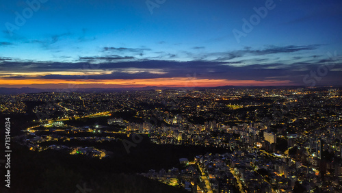 Dusk on top of a mountain in the highest part of the city of Belo Horizonte in Brazil. Sunset and city lights slowly turning on.